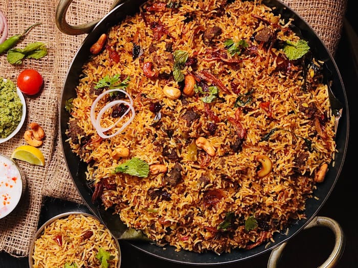 Chicken biryani served in a traditional pan