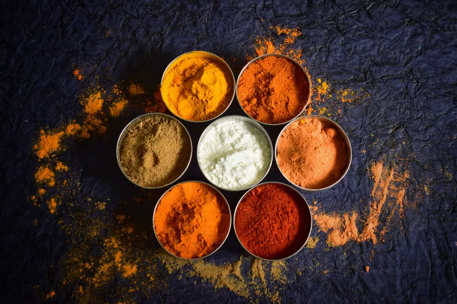 Ground spices in brass bowls